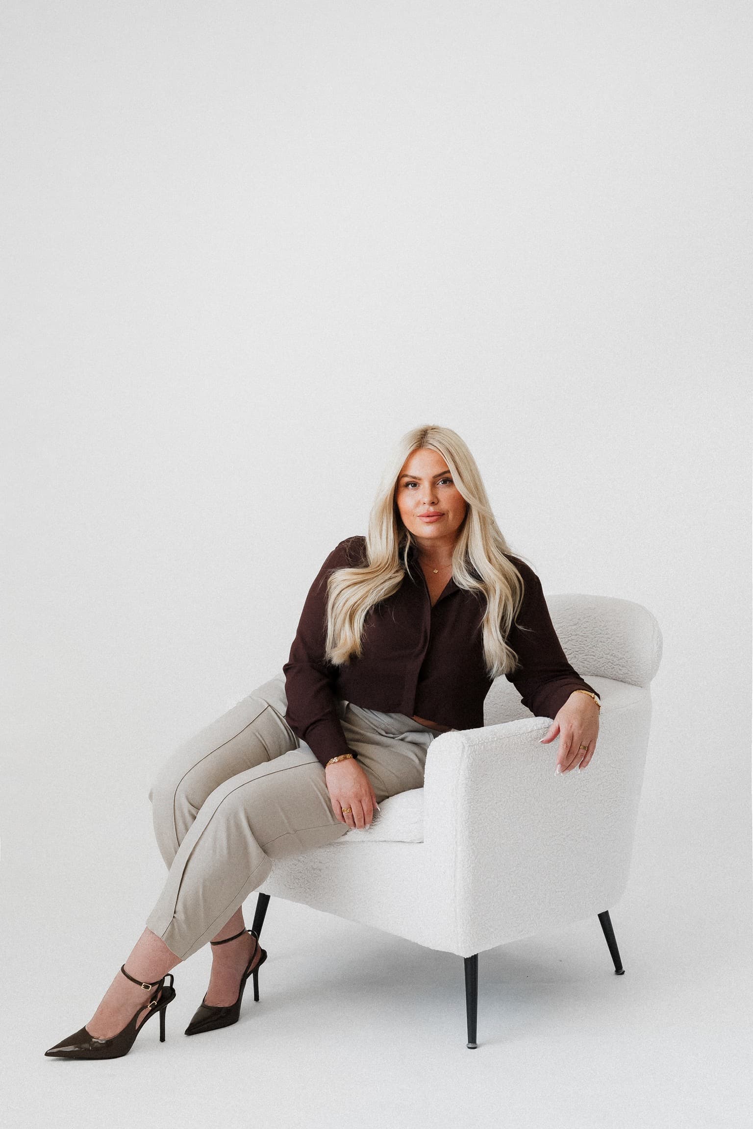 Grace Bailey seated in a minimal studio portrait